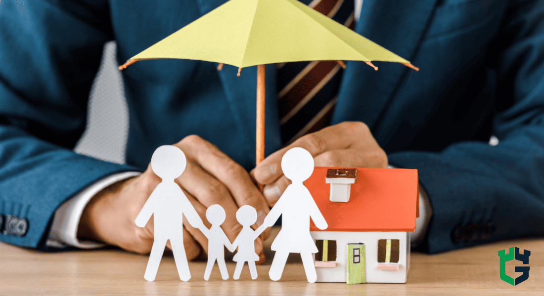 Insurance advisor sheltering paper cutout family and house under umbrella