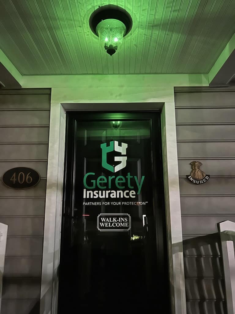 Gerety Insurance glass door under green light, 'Walk-Ins Welcome'.