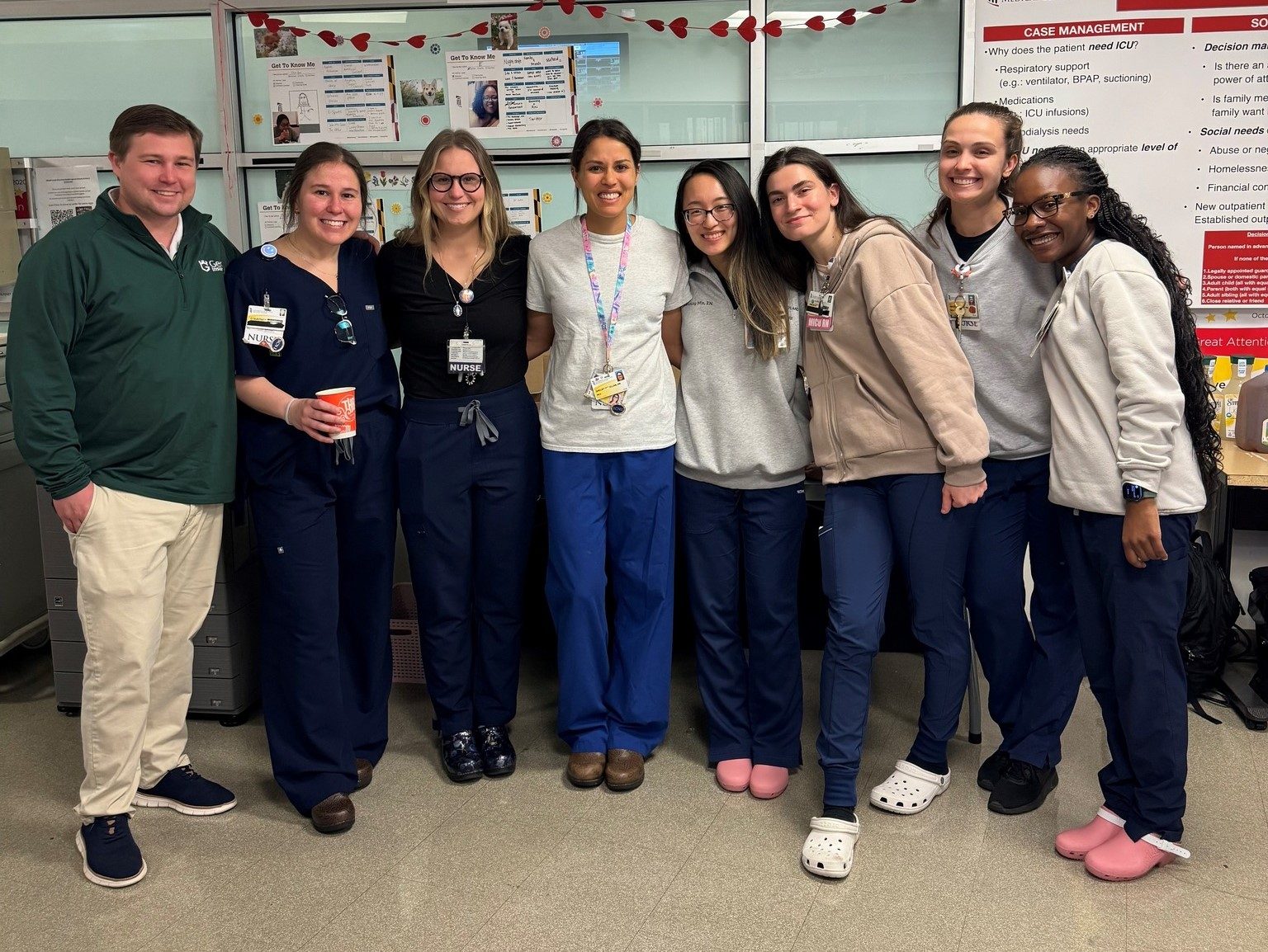 Group of smiling nurses and staff in scrubs standing together