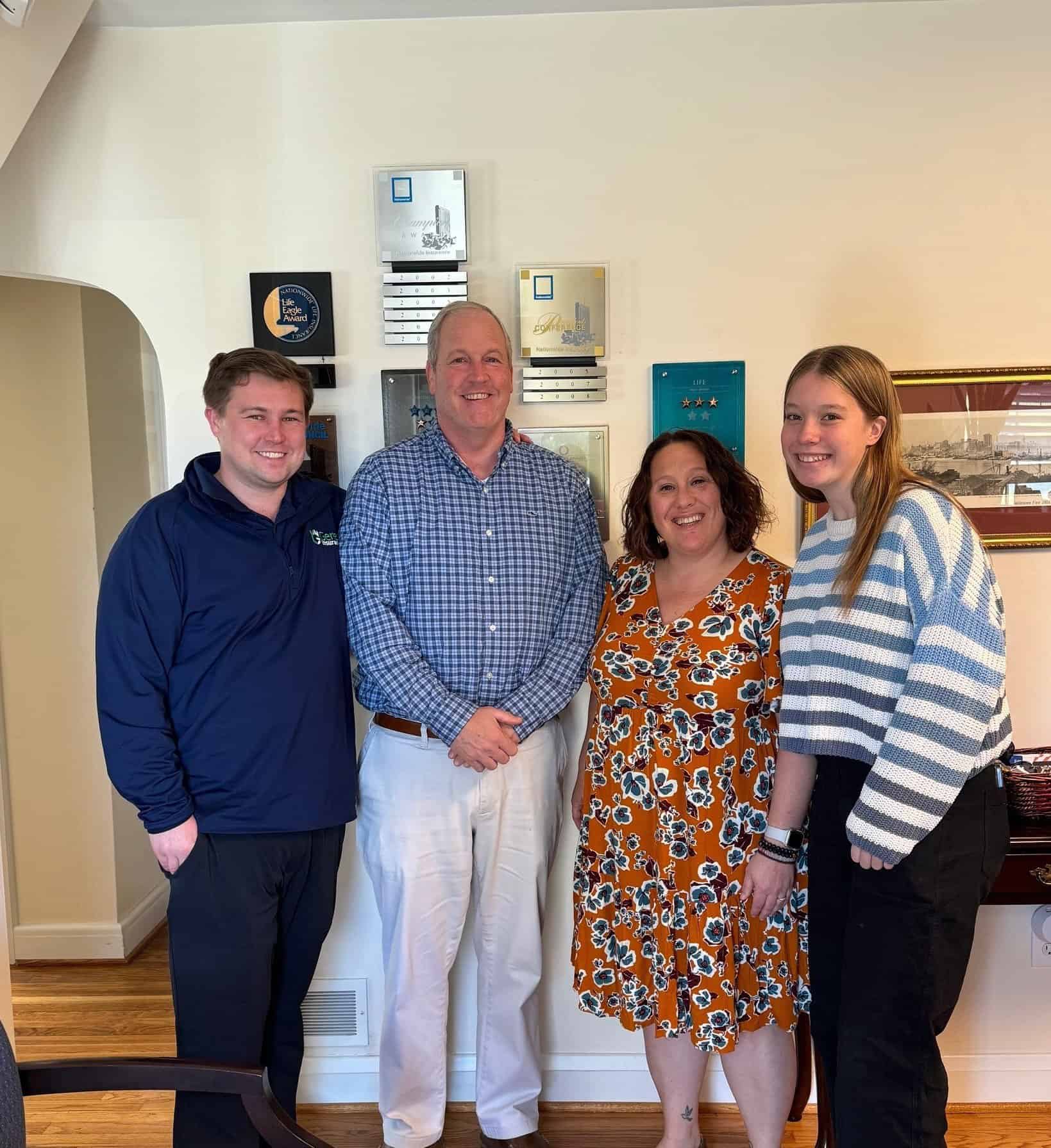Three Gerety Insurance employees and a business education student posing in the Gerety office
