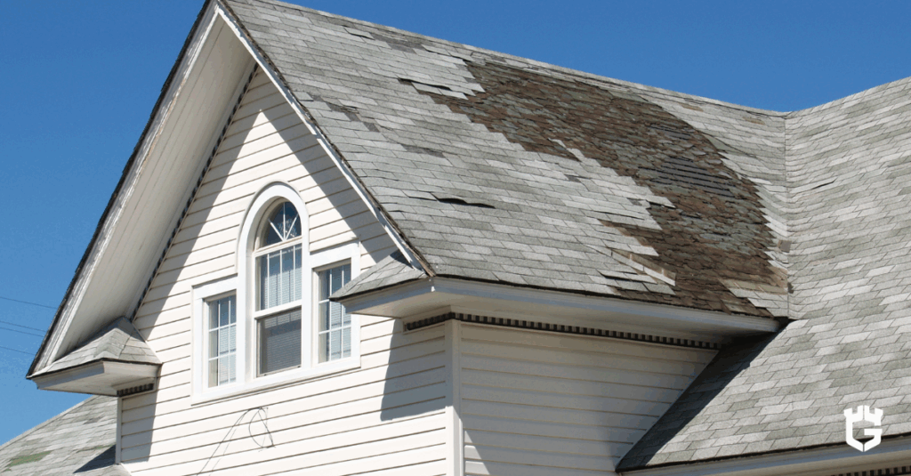 Gable with arched window and large area of missing roof shingles