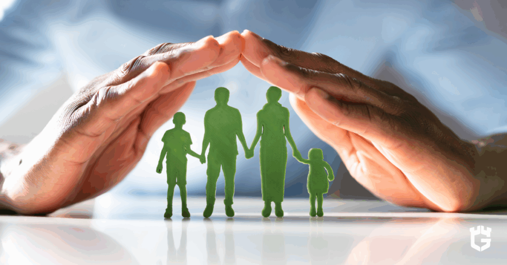 Hands sheltering a green paper-cut family of four