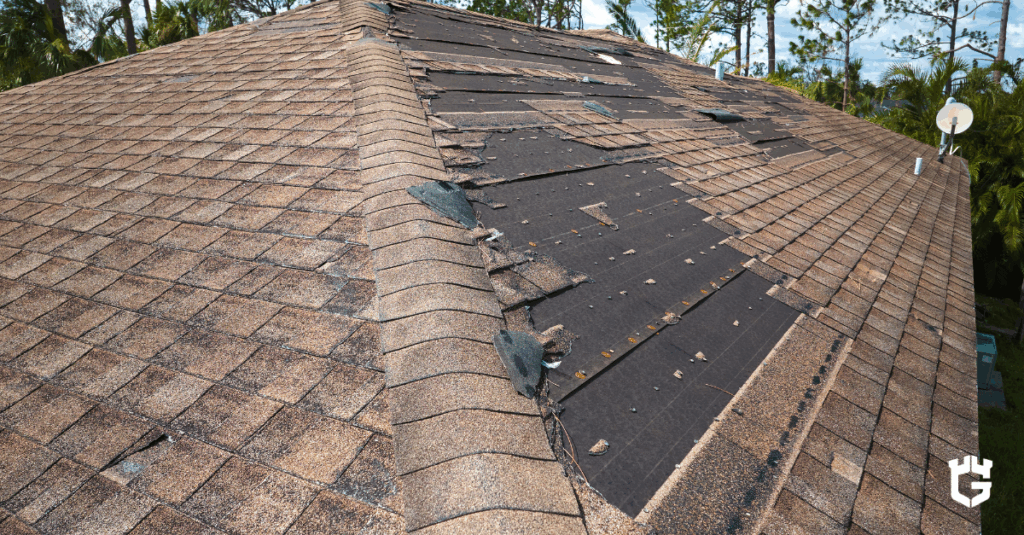Roof with missing shingles and exposed black underlayment