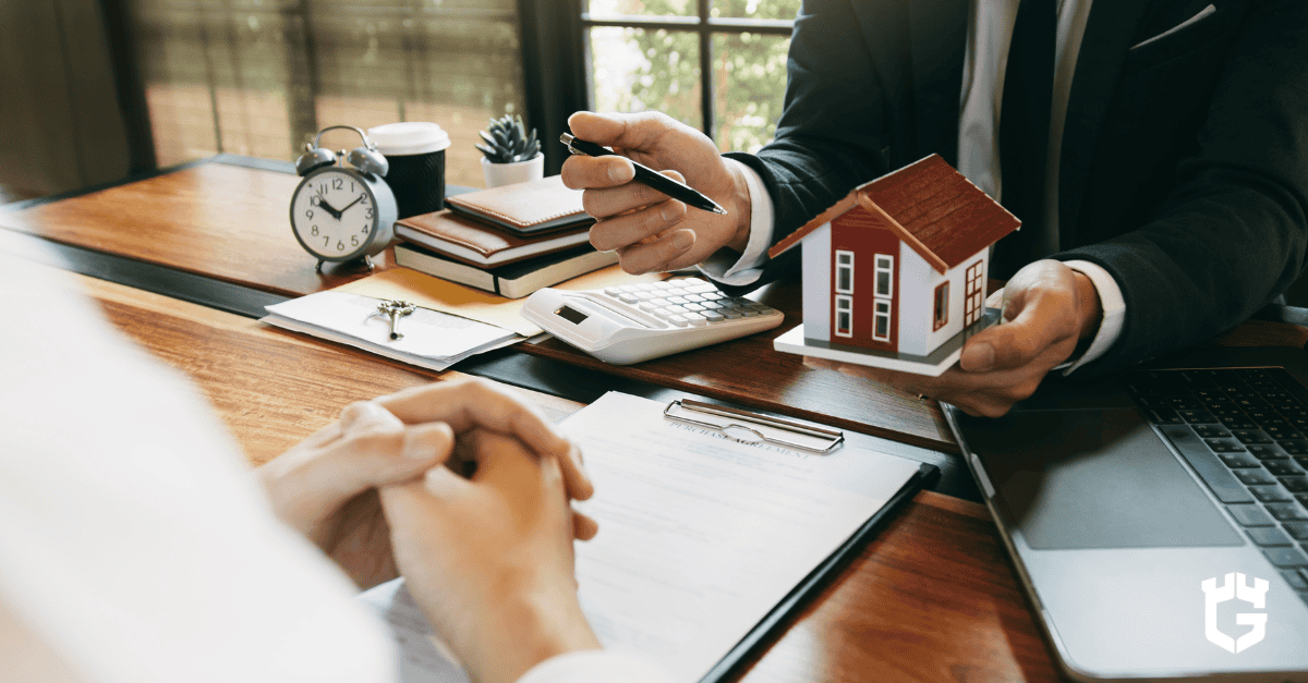 Insurance agent holding a model house while discussing policy customization options with a client