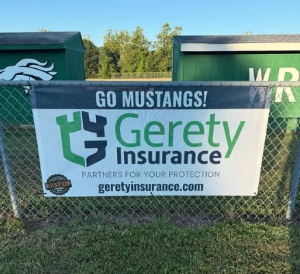 Go Mustangs! Gerety Insurance banner on chain-link fence