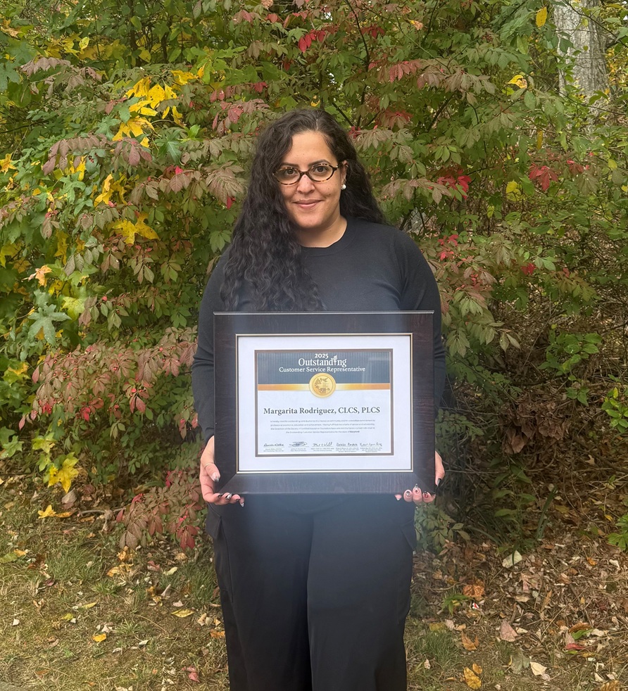 Margarita Rodriguez posing outside with award