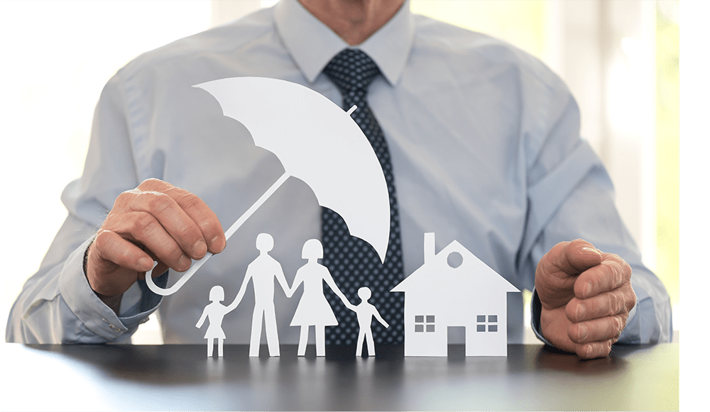 Insurance agent sheltering paper cutout family and house with umbrella