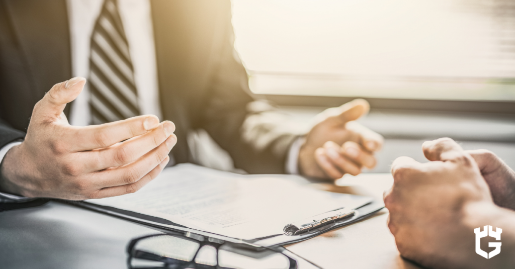 Two people reviewing insurance documents at a desk